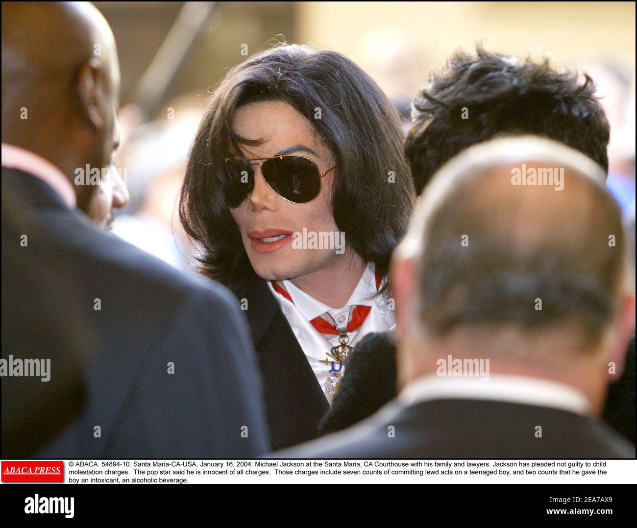 © ABACA. 54894-10. Santa Maria-CA-USA, January 16, 2004. Michael Jackson at the Santa Maria, CA Courthouse with his family and lawyers. Jackson has pleaded not guilty to child molestation charges. The pop star said he is innocent of all charges. Those charges include seven counts of committing lewd acts on a teenaged boy, and two counts that he gave the boy an intoxicant, an alcoholic beverage. Stock Photo