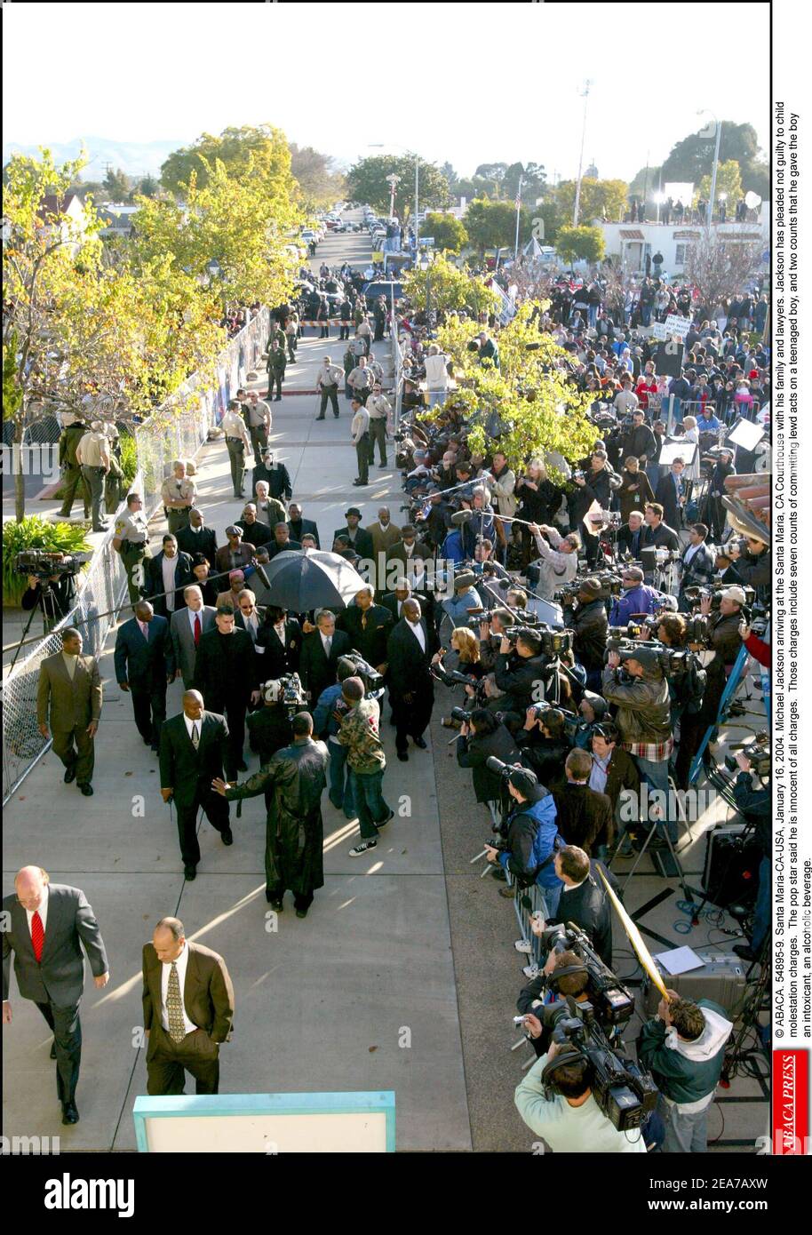 © ABACA. 54895-9. Santa Maria-CA-USA, January 16, 2004. Michael Jackson arriving at the Santa Maria, CA Courthouse with his family and lawyers. Jackson has pleaded not guilty to child molestation charges. The pop star said he is innocent of all charges. Those charges include seven counts of committing lewd acts on a teenaged boy, and two counts that he gave the boy an intoxicant, an alcoholic beverage. Stock Photo