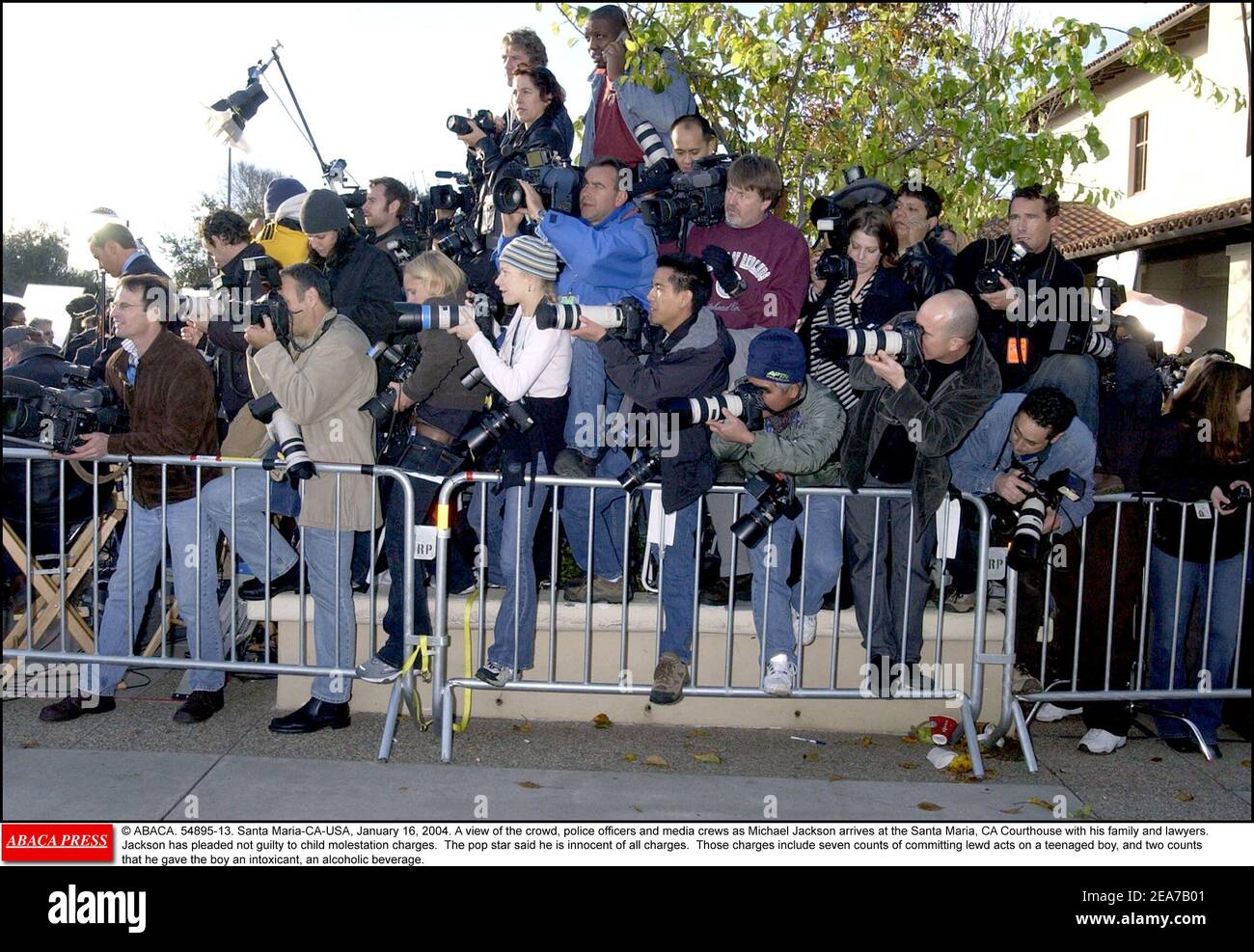© ABACA. 54895-13. Santa Maria-CA-USA, January 16, 2004. A view of the crowd, police officers and media crews as Michael Jackson arrives at the Santa Maria, CA Courthouse with his family and lawyers. Jackson has pleaded not guilty to child molestation charges. The pop star said he is innocent of all charges. Those charges include seven counts of committing lewd acts on a teenaged boy, and two counts that he gave the boy an intoxicant, an alcoholic beverage. Stock Photo