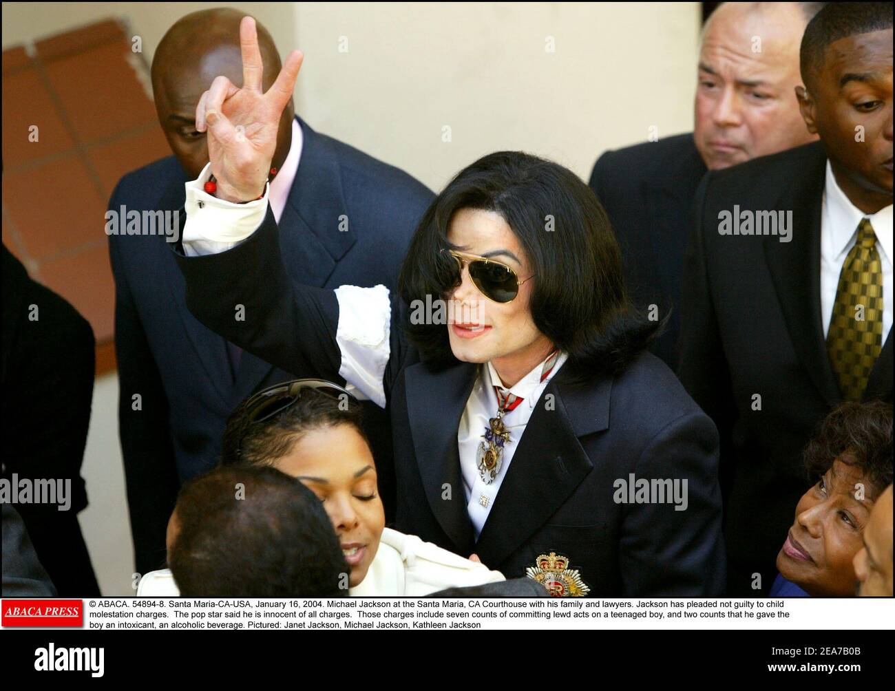 © ABACA. 54894-8. Santa Maria-CA-USA, January 16, 2004. Michael Jackson at the Santa Maria, CA Courthouse with his family and lawyers. Jackson has pleaded not guilty to child molestation charges. The pop star said he is innocent of all charges. Those charges include seven counts of committing lewd acts on a teenaged boy, and two counts that he gave the boy an intoxicant, an alcoholic beverage. Pictured: Janet Jackson, Michael Jackson, Kathleen Jackson Stock Photo