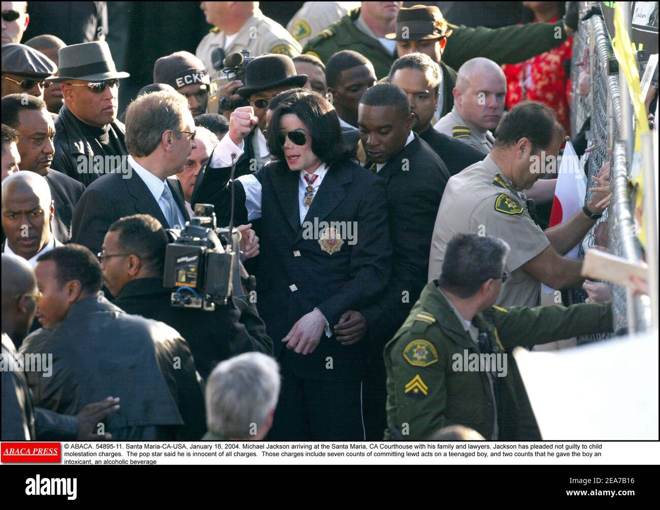 © ABACA. 54895-11. Santa Maria-CA-USA, January 16, 2004. Michael Jackson arriving at the Santa Maria, CA Courthouse with his family and lawyers. Jackson has pleaded not guilty to child molestation charges. The pop star said he is innocent of all charges. Those charges include seven counts of committing lewd acts on a teenaged boy, and two counts that he gave the boy an intoxicant, an alcoholic beverage Stock Photo