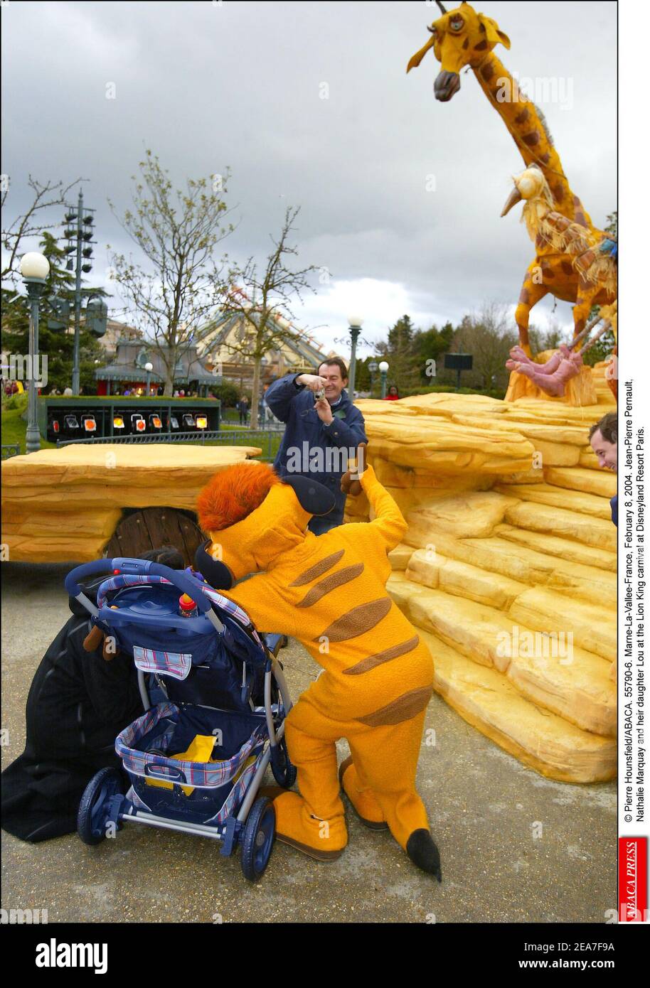 © Pierre Hounsfield/ABACA. 55790-6. Marne-La-Vallee-France, February 8, 2004. Jean-Pierre Pernaut, Nathalie Marquay and their daughter Lou at the Lion King carnival at Disneyland Resort Paris. Stock Photo