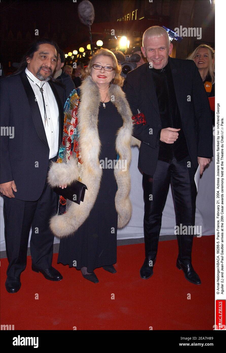© Arnal-Nebinger/ABACA. 56288-5. Paris-France, February 21, 2004. Actress Josiane Balasko flanked by her boyfriend George Aguilar (L) and Jean-Paul Gaultier arrives at the 29th Cesar awards ceremony held at the Theatre du Chatelet in Paris. Stock Photo