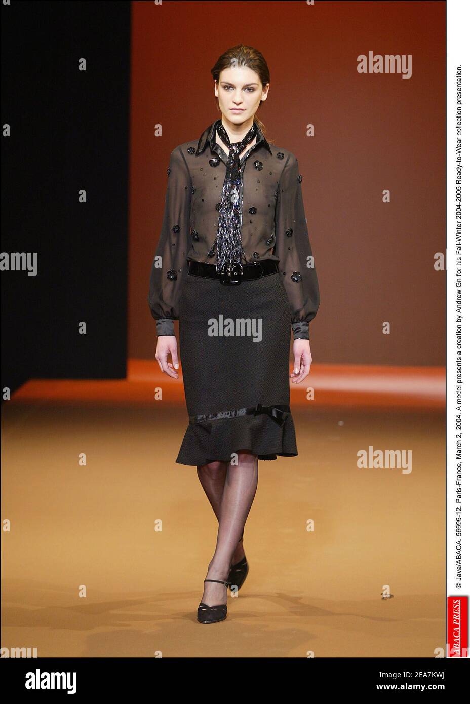 © Java/ABACA. 56696-12. Paris-France, March 2, 2004. A model presents a creation by Andrew Gn for his Fall-Winter 2004-2005 Ready-to-Wear collection presentation. Stock Photo