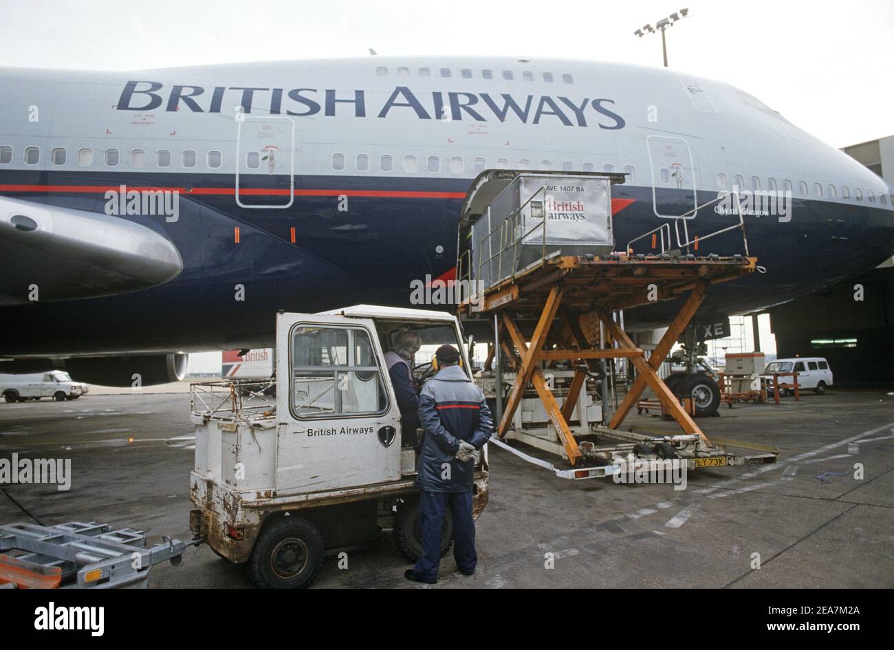 British Airways jumbo jet luggage pods at Heathrow Airport airside