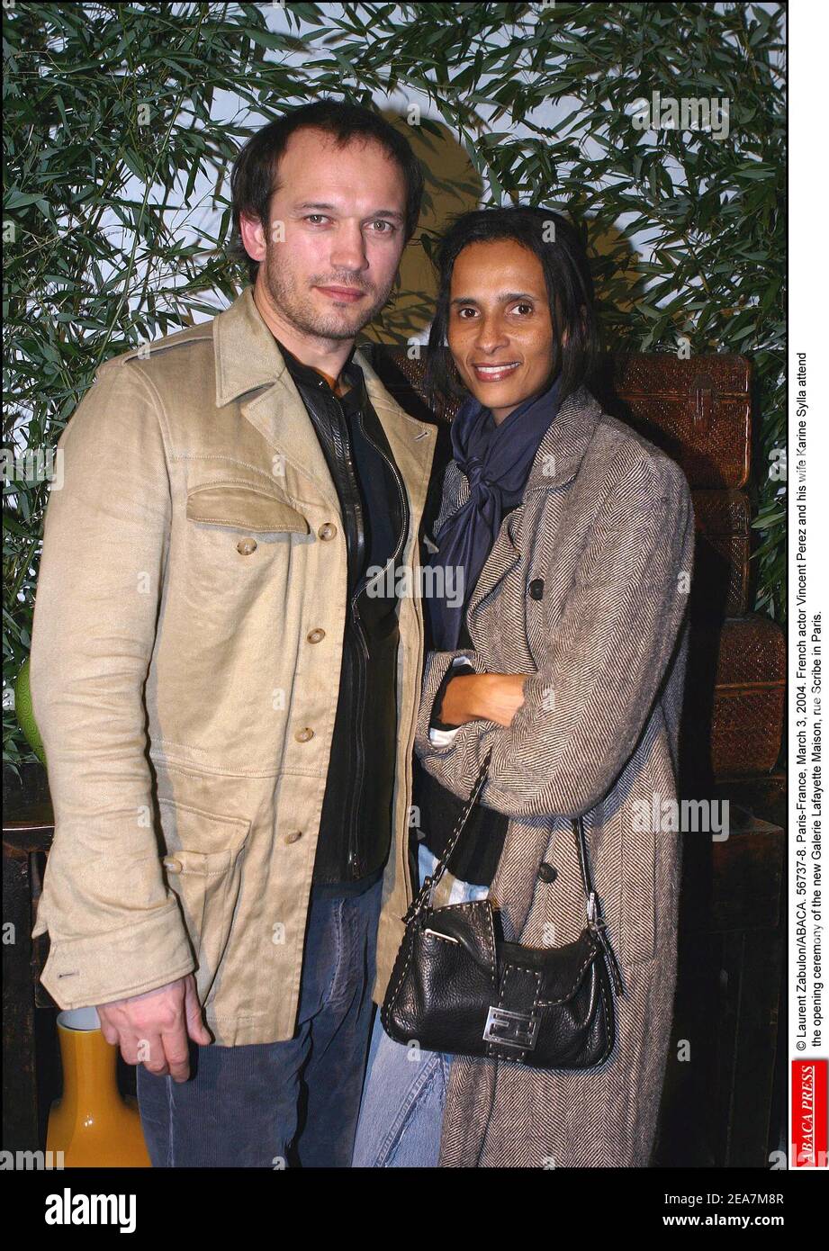 © Laurent Zabulon/ABACA. 56737-8. Paris-France, March 3, 2004. Swiss actor Vincent Perez and his wife Karine Sylla attend the opening ceremony of the new Galerie Lafayette Maison, rue Scribe in Paris. Stock Photo