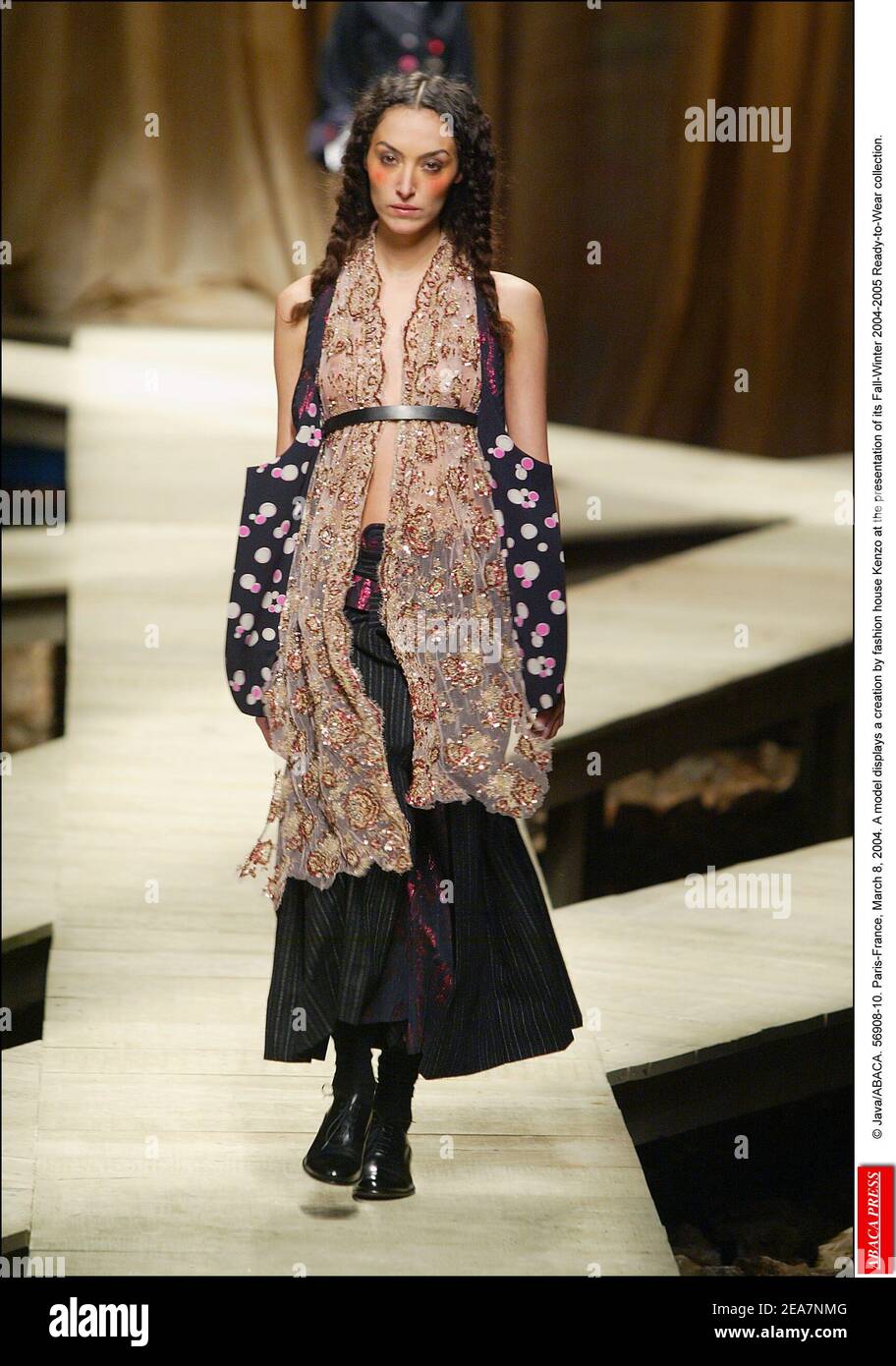 © Java/ABACA. 56908-10. Paris-France, March 8, 2004. A model displays a creation by fashion house Kenzo at the presentation of its Fall-Winter 2004-2005 Ready-to-Wear collection. Stock Photo