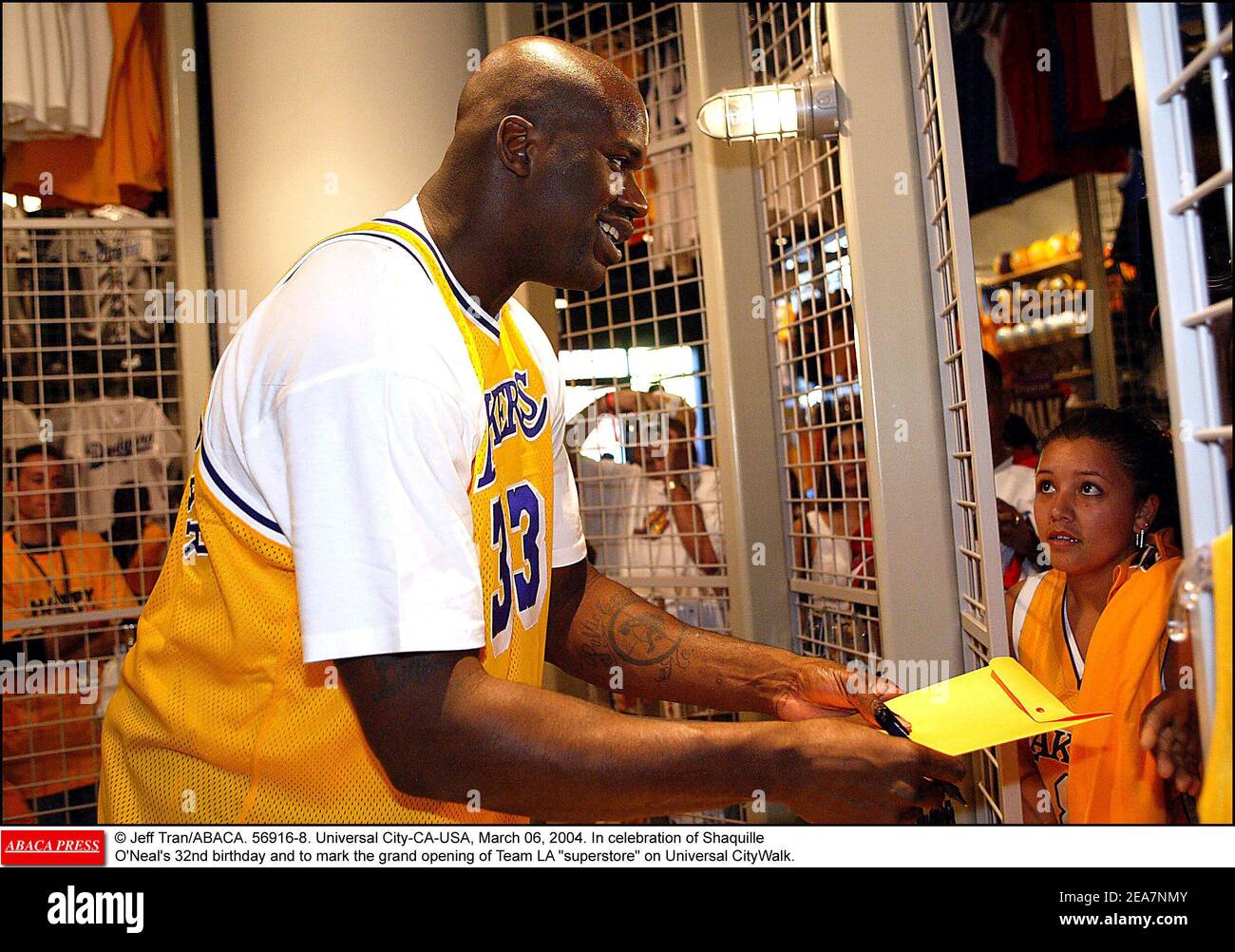 © Jeff Tran/ABACA. 56916-8. Universal City-CA-USA, March 06, 2004. In celebration of Shaquille O'Neal's 32nd birthday and to mark the grand opening of Team LA superstore on Universal CityWalk, Shaquille unveils a 40 feet tall neon sign in his likeness sporting his famous number 34 Lakers Jersey. However, Shaquille attends the event wearing a Lakers Jersey number 33 which was once worn by a retired Lakers player, Kareem Abdul-Jabar. Stock Photo