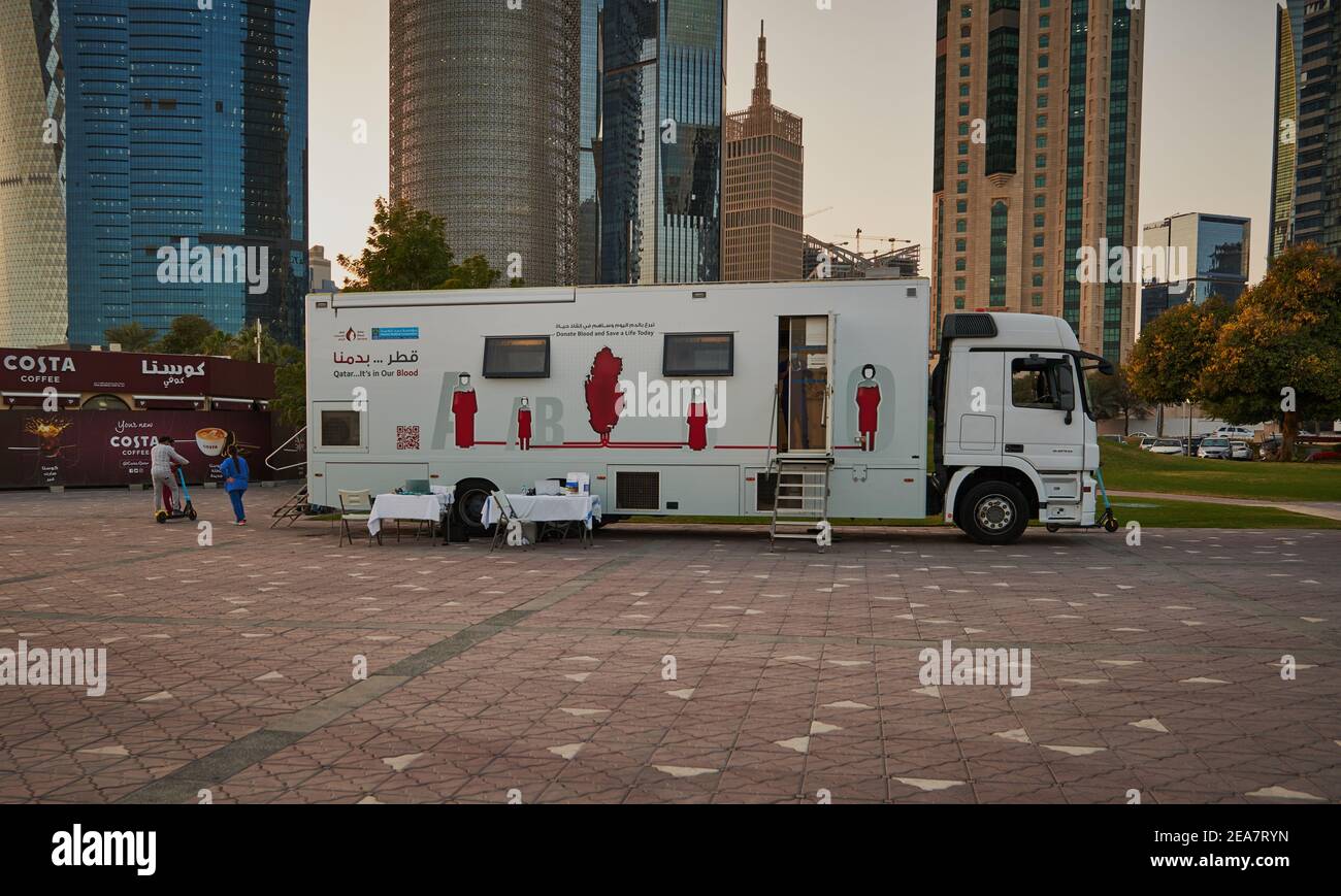 Blood donation campaign in Doha Qatar with blood donation mobile unit from Hamad medical corporation standing in Sheraton park with skylines Stock Photo