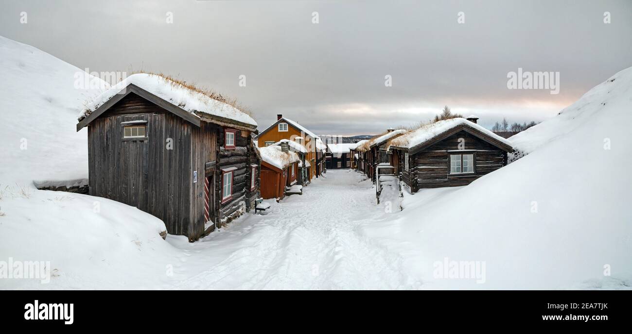 Snow covered street and buildings in Roros Norway. Norwegian mining town under snow. Old wooden houses. Panoramic view. Stock Photo