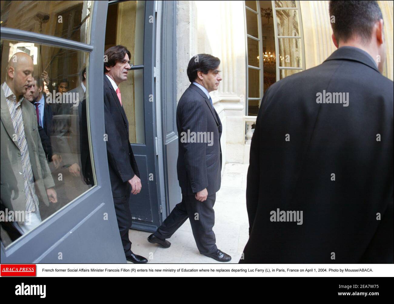 French former Social Affairs Minister Francois Fillon (R) enters his new ministry of Education where he replaces departing Luc Ferry (L), in Paris, France on April 1, 2004. Photo by Mousse/ABACA. Stock Photo