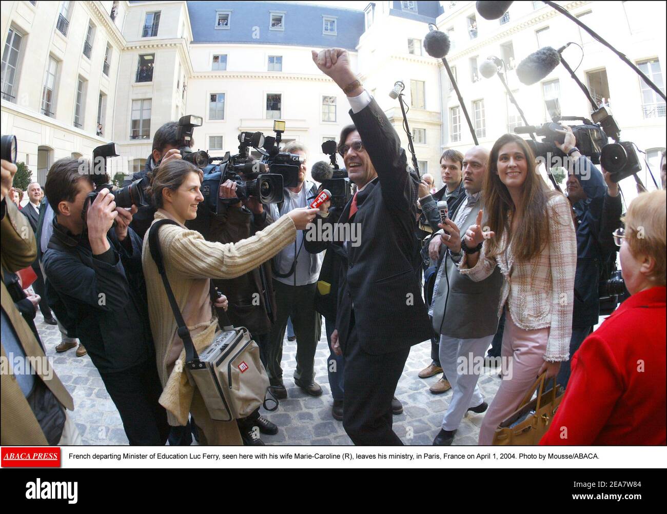 French departing Minister of Education Luc Ferry, seen here with his wife Marie-Caroline (R), leaves his ministry, in Paris, France on April 1, 2004. Photo by Mousse/ABACA. Stock Photo