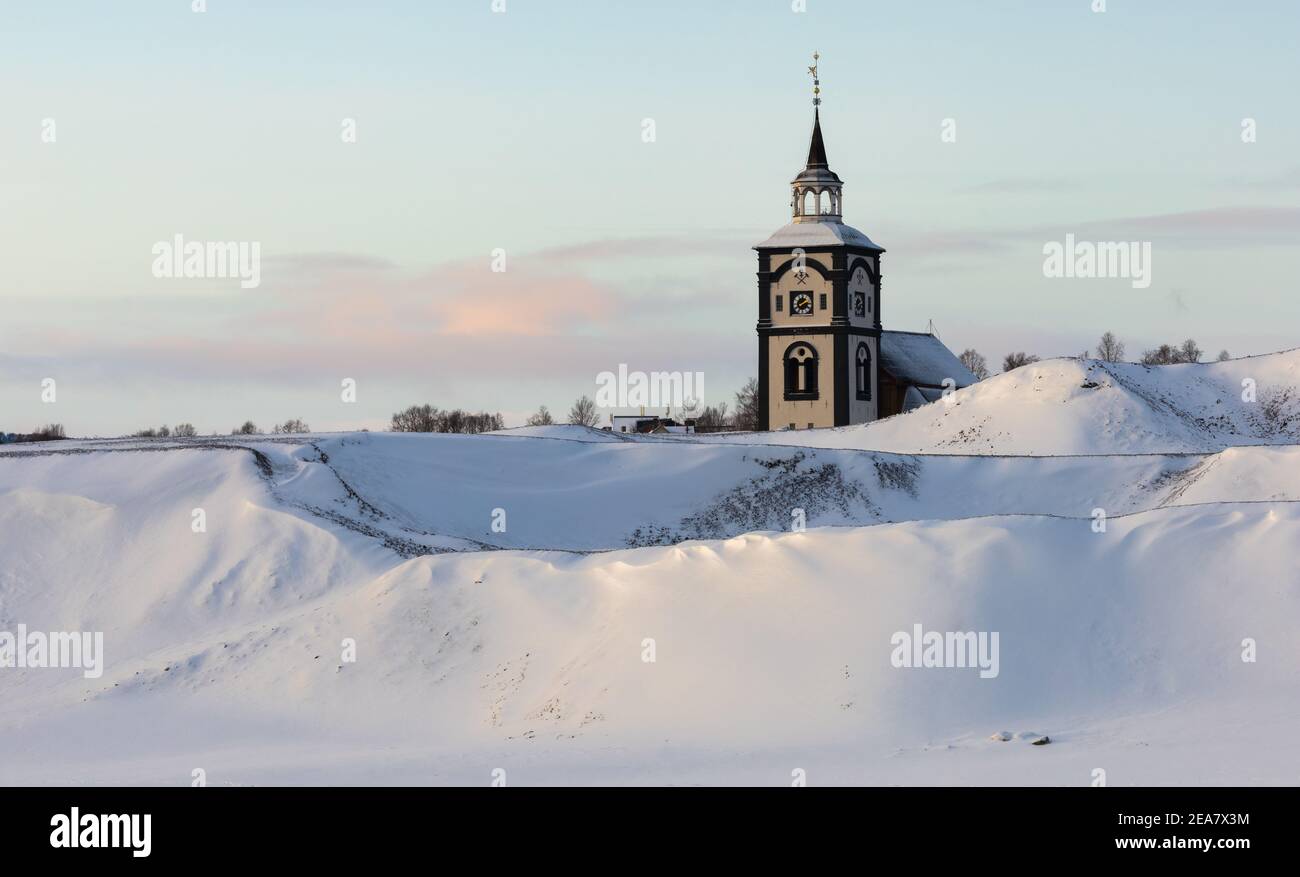 Røros church and its characteristic clock tower. Snowy wintertime in old, historical mining town. Norwegian historical place listed by UNESCO. Stock Photo