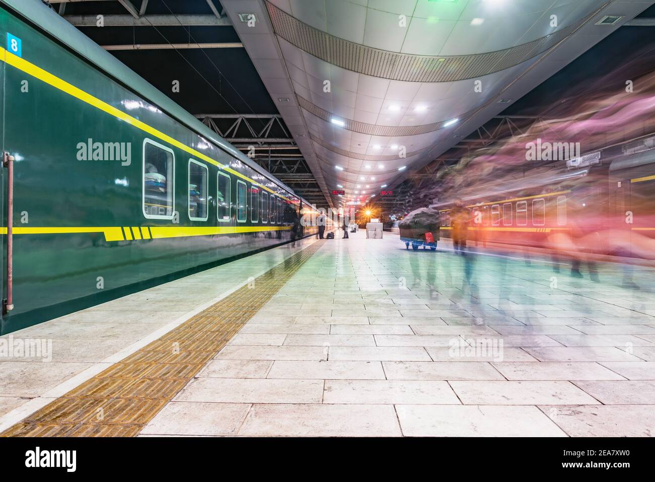Passenger trains stand by the platform at evening time Stock Photo Alamy