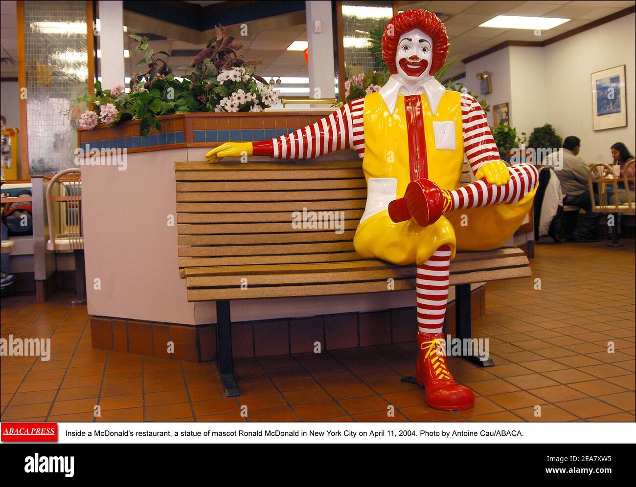 Inside a McDonald's restaurant, a statue of mascot Ronald McDonald in New York City on April 11, 2004. Photo by Antoine Cau/ABACA. Stock Photo