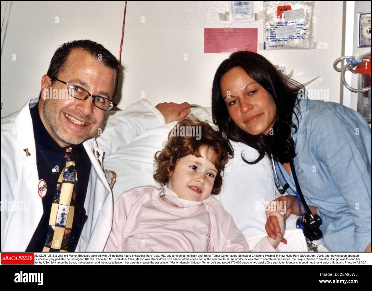 EXCLUSIVE. Six-year-old Manon Beauvais pictured with US pediatric neuro-oncologist Mark Atlas, MD, and a nurse at the Brain and Spinal Tumor Center at the Schneider Children's Hospital in New Hyde Park-USA on April 2003, after having been operated successfully by pediatric neurosurgeon Steven Schneider, MD, and Mark Atlas. Manon was struck down by a cancer of the cheek and of the cerebral trunk. As no doctor was able to operate her in France, the unique chance to savethe little girl was to send her to the USA. To finance the travel, the operation and the hospitalization, her parents created th Stock Photo