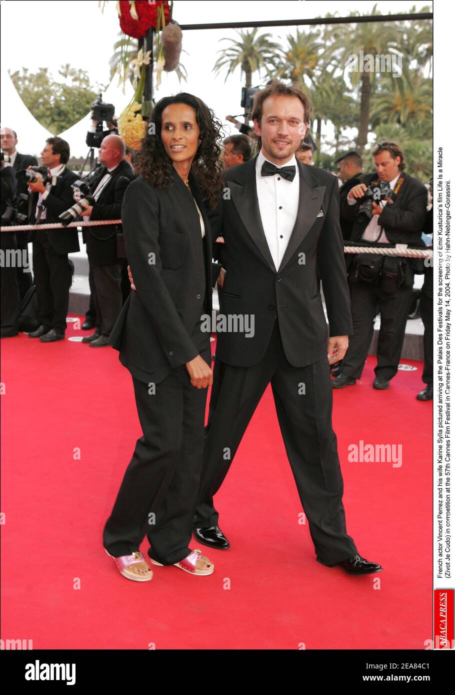 Swiss actor Vincent Perez and his wife Karine Sylla pictured arriving at the Palais Des Festivals for the screening of Emir Kusturica's film Life Is a Miracle (Zivot Je Cudo) in competition at the 57th Cannes Film Festival in Cannes-France on Friday May 14, 2004. Photo by Hahn-Nebinger-Gorassini. Stock Photo