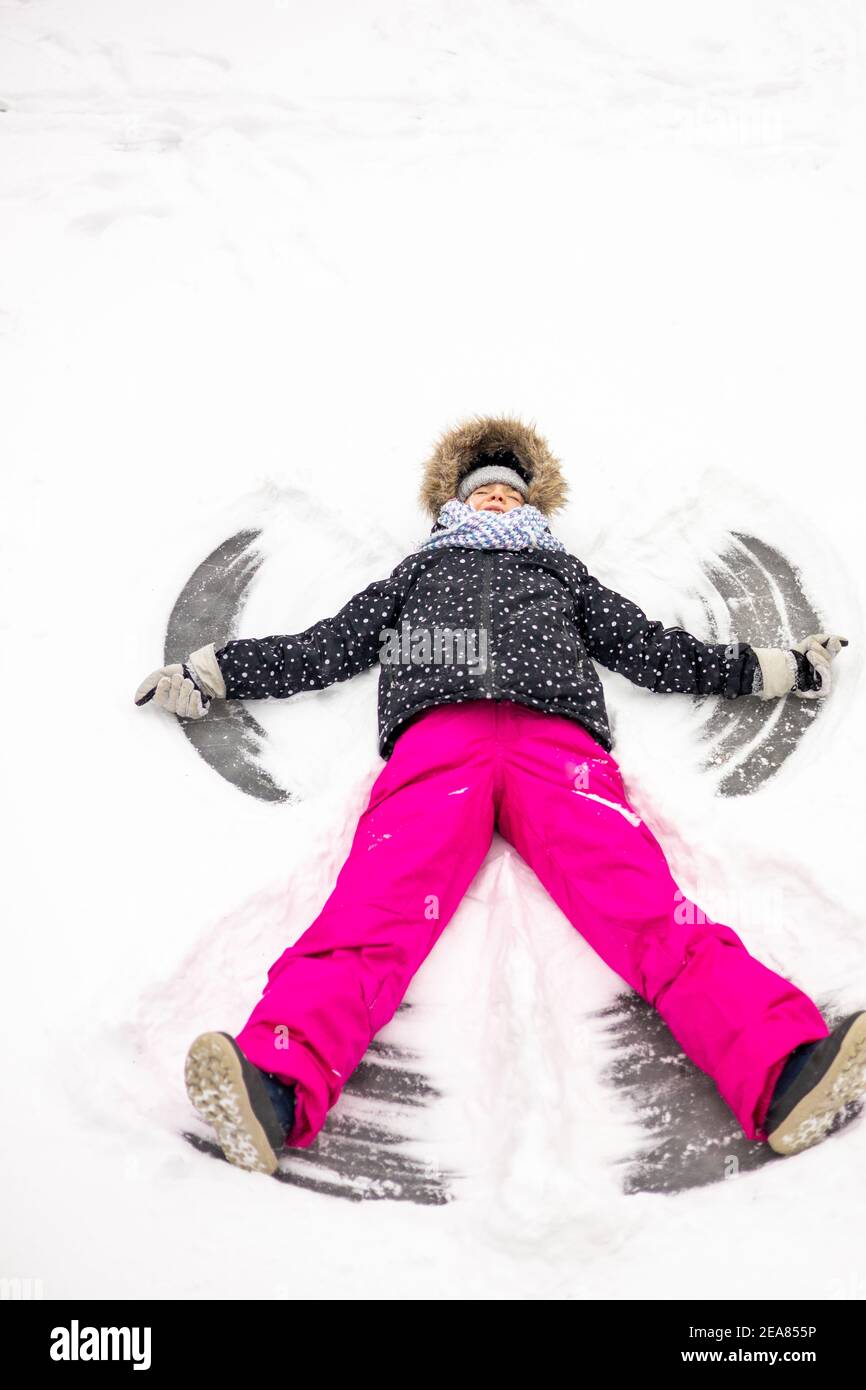 Young girl making a snow angel Stock Photo Alamy
