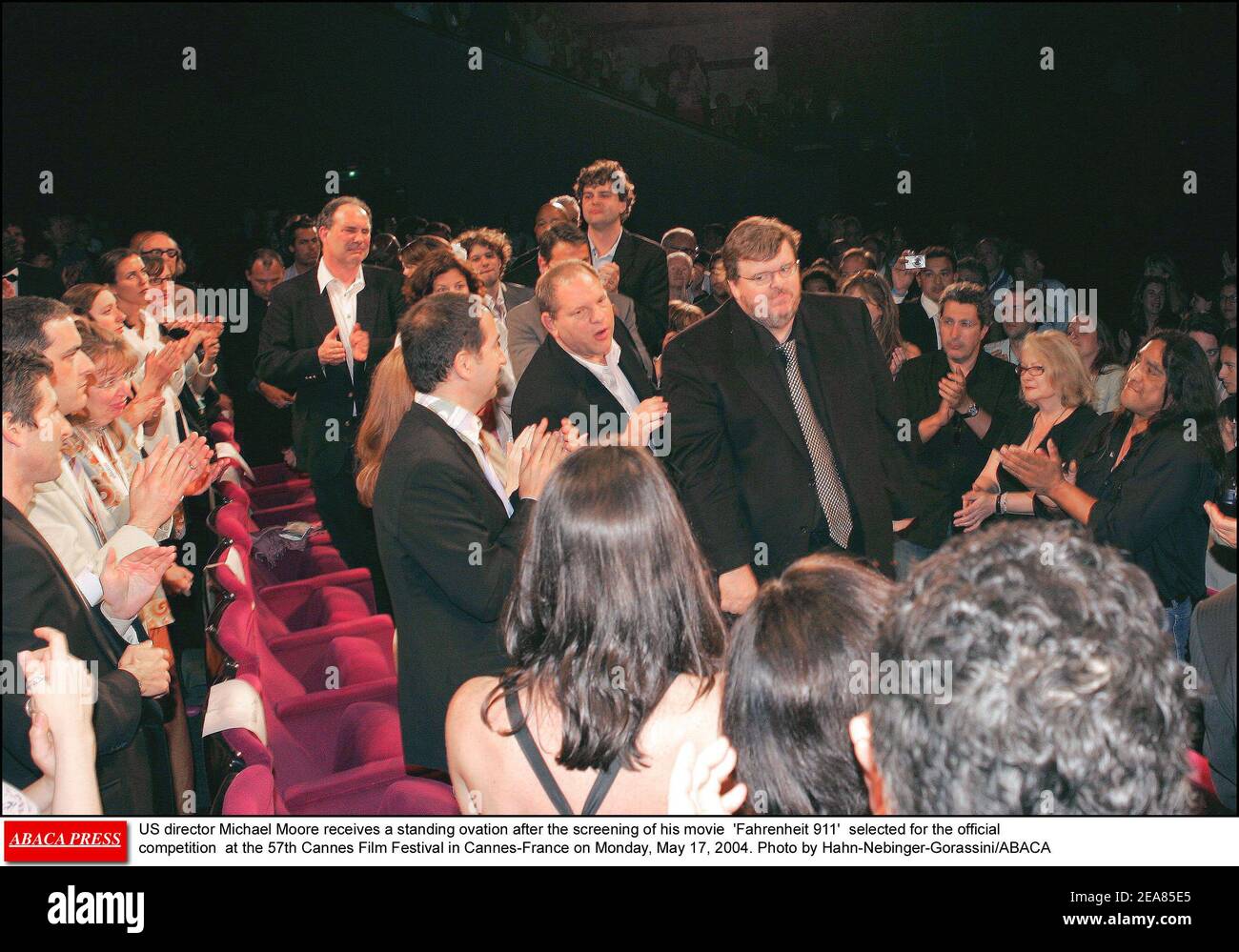 US director Michael Moore receives a standing ovation after the screening of his movie 'Fahrenheit 911' selected for the official competition at the 57th Cannes Film Festival in Cannes-France on Monday, May 17, 2004. Photo by Hahn-Nebinger-Gorassini/ABACA Stock Photo