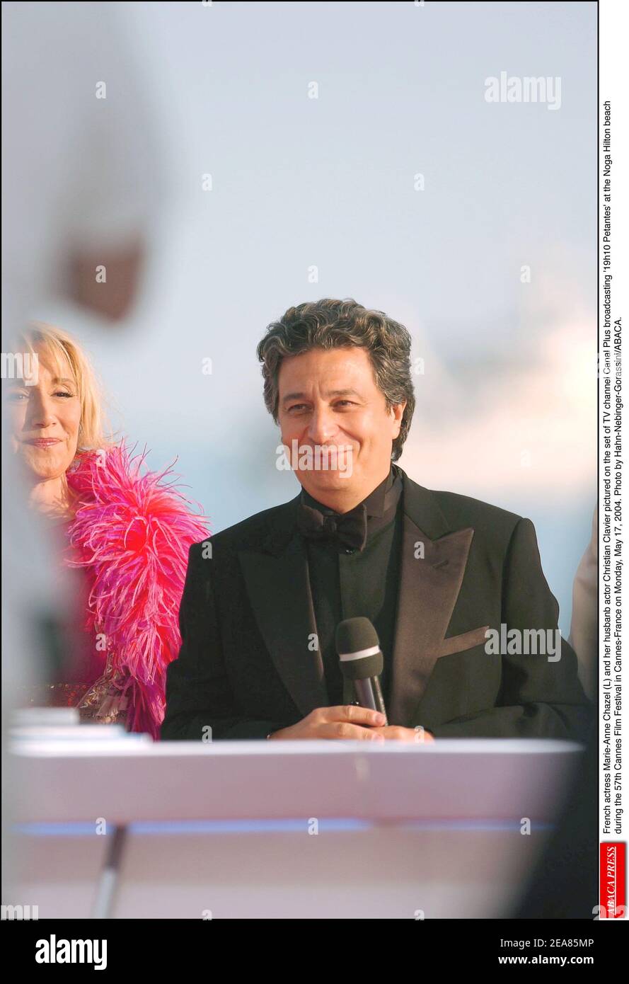 French actress Marie-Anne Chazel (L) and her husbanb actor Christian Clavier  pictured on the set of TV channel Canal Plus broadcasting '19h10 Petantes'  at the Noga Hilton beach during the 57th Cannes