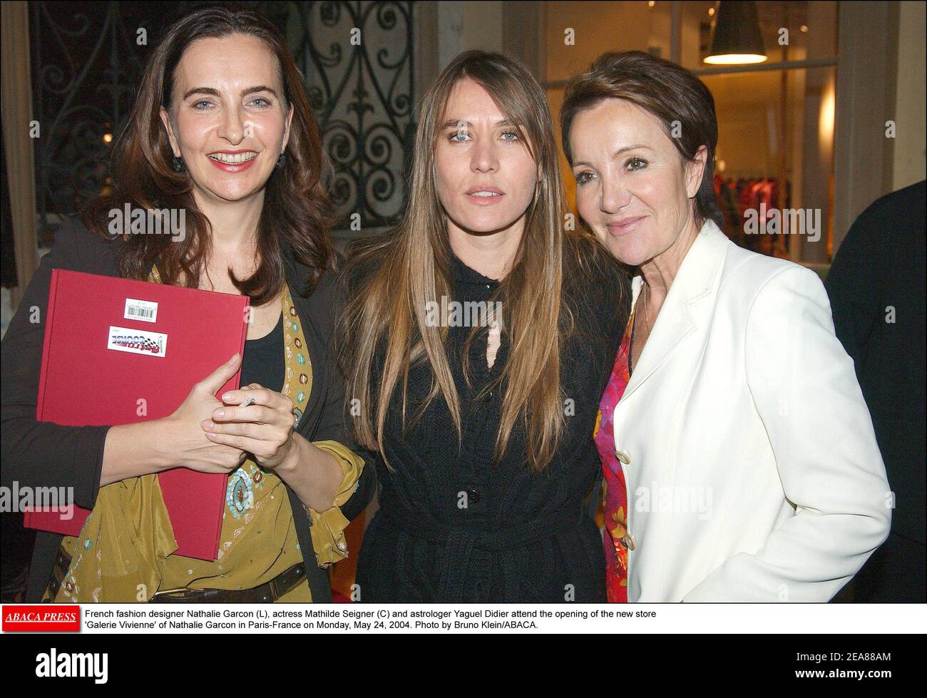 French fashion designer Nathalie Garcon (L), actress Mathilde Seigner (C) and astrologer Yaguel Didier attend the opening of the new store 'Galerie Vivienne' of Nathalie Garcon in Paris-France on Monday, May 24, 2004. Photo by Bruno Klein/ABACA. Stock Photo