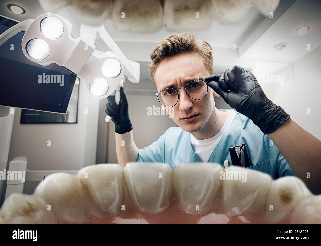 Preparing. Doctor looking into mouth, checking, examining teeth. Using professional tools and equipments. Healthcare and medicine, stomatology, feelings of patient. Look from inside the teeth. Stock Photo