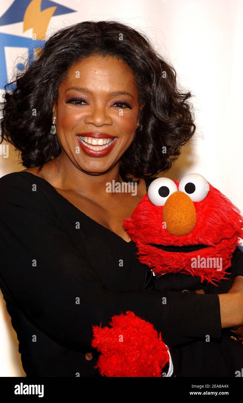 Oprah Winfrey poses with Elmo as she arrives at the Sesame Workshop 2nd