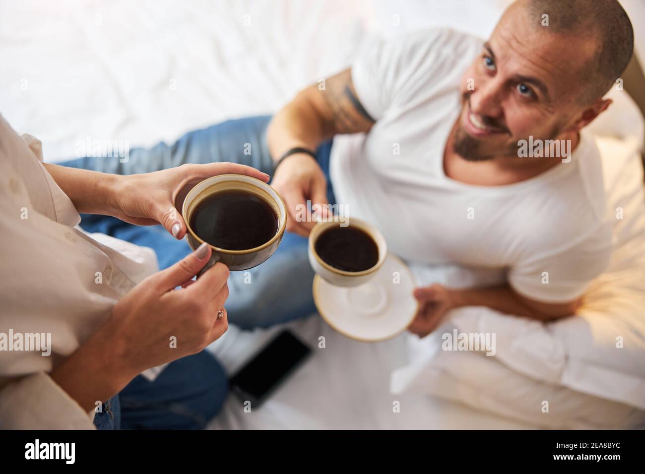 Happy husband drinking coffee with his female spouse Stock Photo Alamy