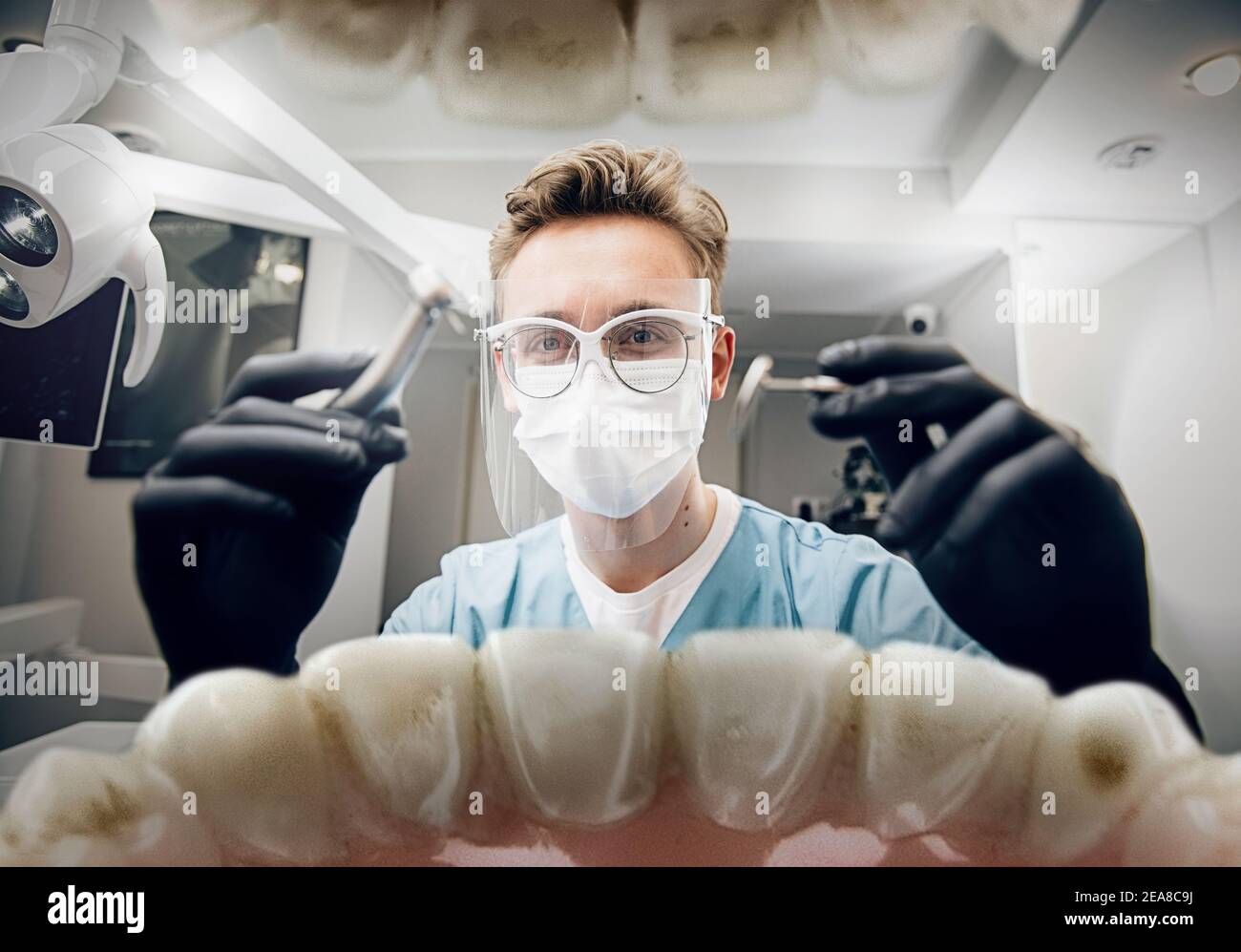 Medicine. Doctor looking into mouth, checking, examining teeth. Using professional tools and equipments. Healthcare and medicine, stomatology, feelings of patient. Look from inside the teeth. Stock Photo