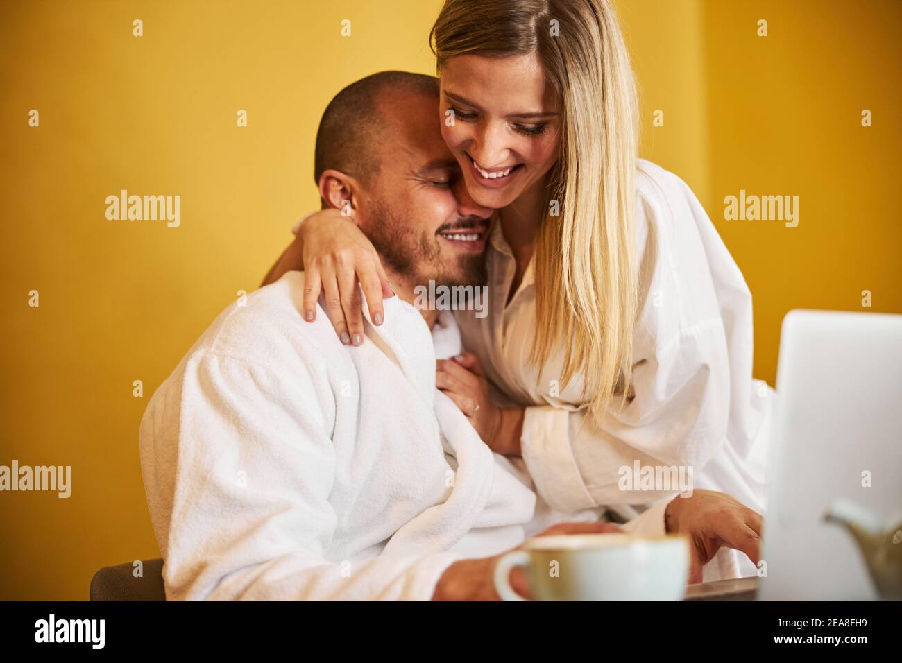 Cheerful wife distracting her husband from work Stock Photo