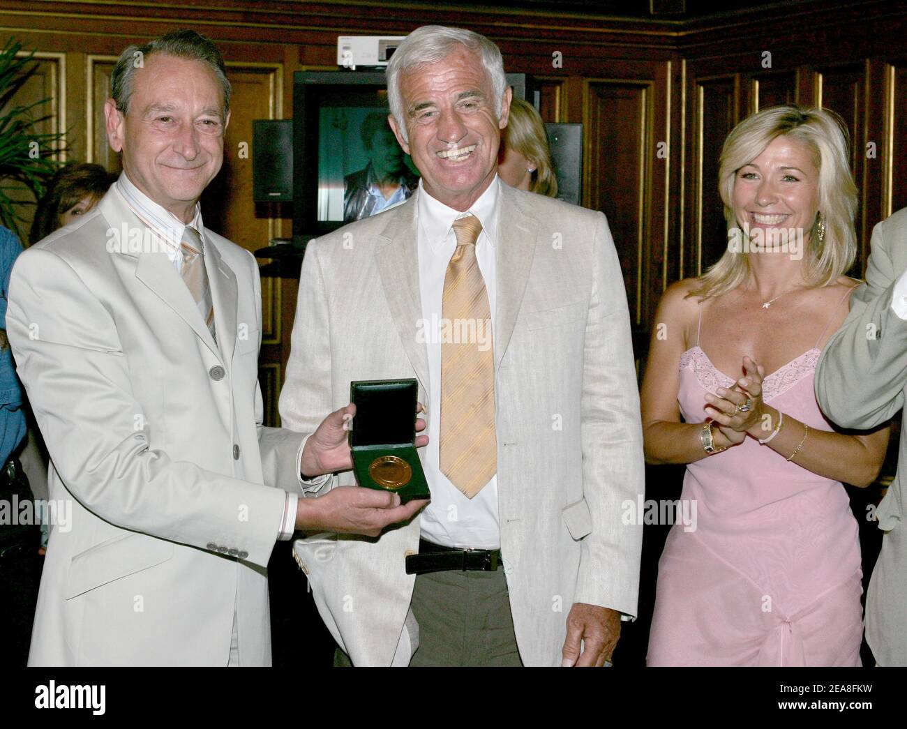 paris Mayor Bertrand Delanoe (L), French actor Jean-Paul Belmondo and his wife Natti pictured during the opening ceremony of the 2nd Festival Paris Cinema at the Hotel de Ville (City Hall) in Paris-France on June 28, 2004. On the occasion Delanoe honored Belmondo with the Medal of the City of Paris. Photo by Laurent Zabulon/ABACA. Stock Photo