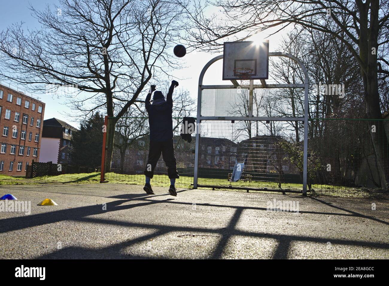 Young man playing basketball alone Stock Photo