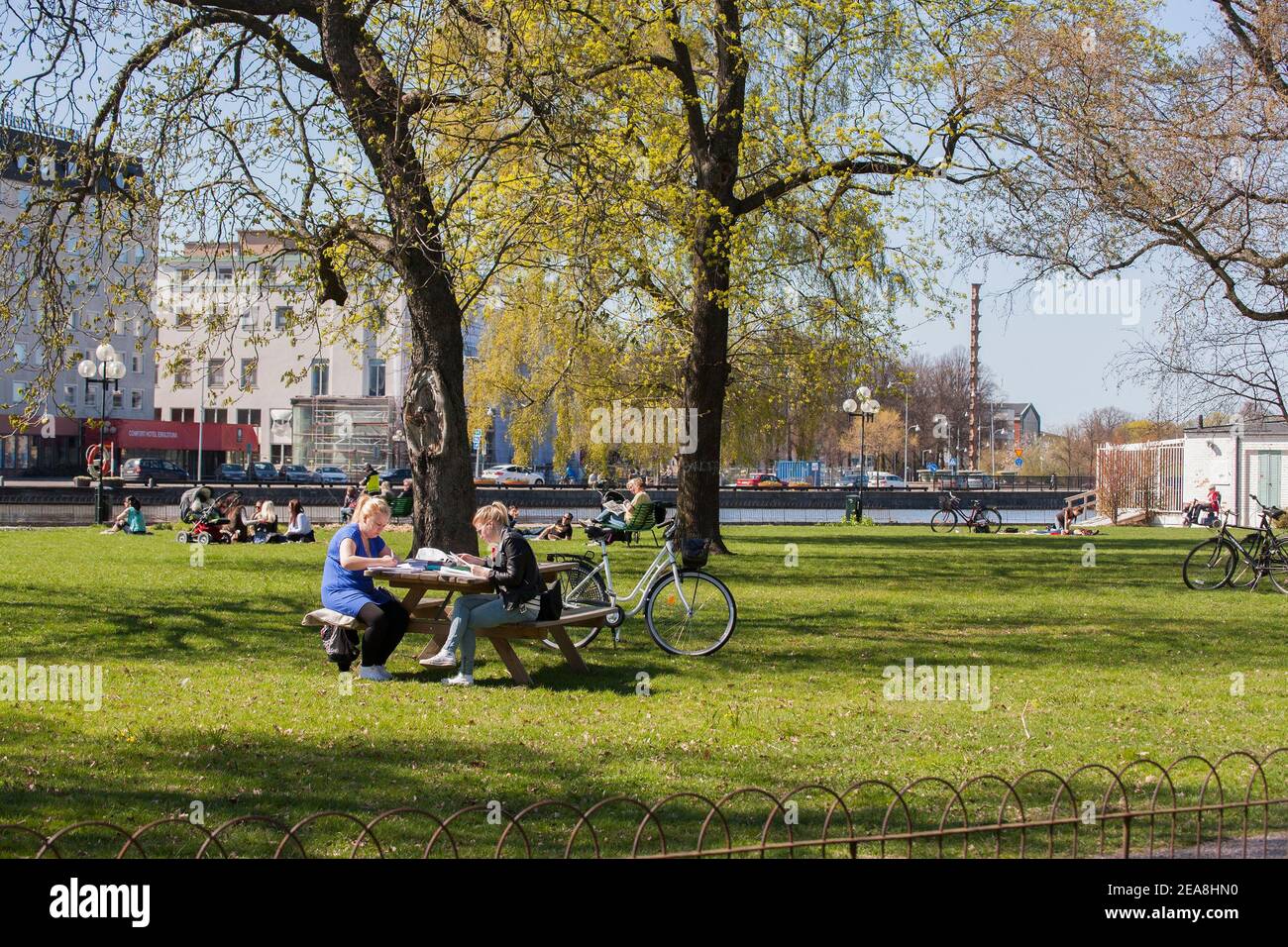 People sitting out in the park first warm day at spring Stock Photo
