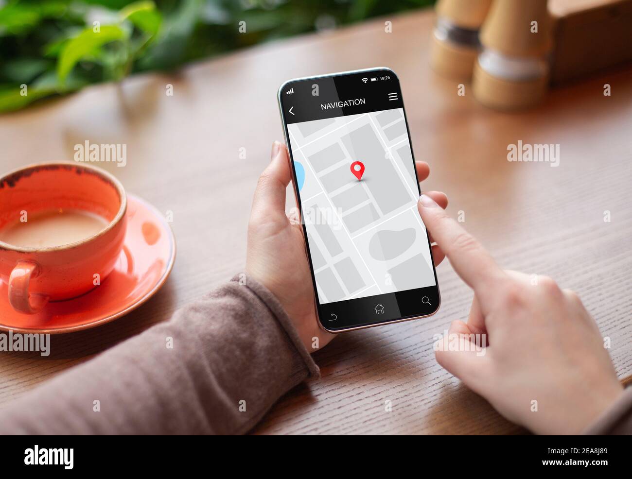 Woman Using Navigation Application On Smartphone Sitting In Cafe, Closeup Stock Photo