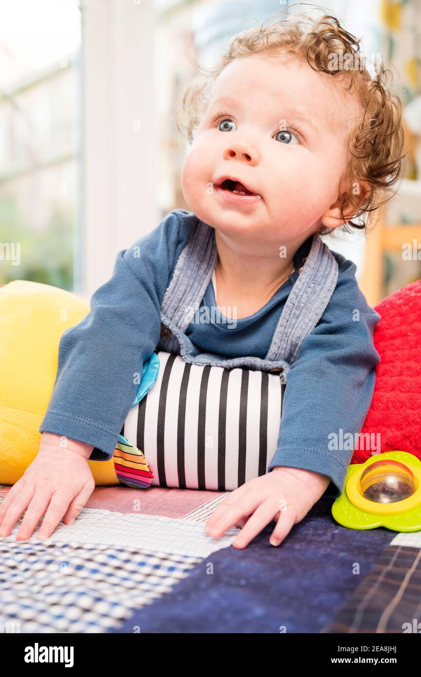 Baby boy using tummy roller Stock Photo
