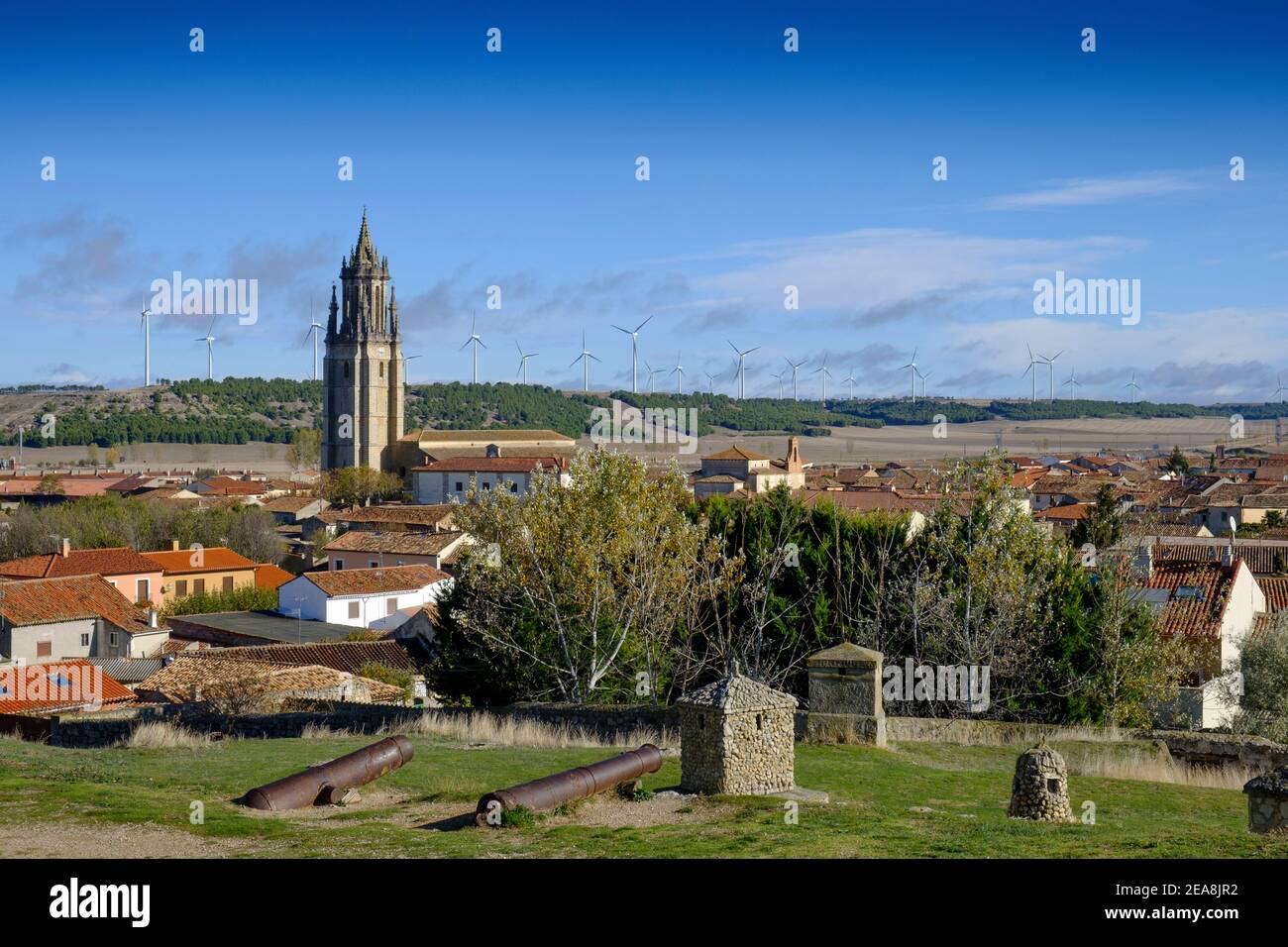 Contast of ancient and modern with wind turbines above the medieval town of Ampudia, Palencia Province, Castilla y Leon, Spain Stock Photo