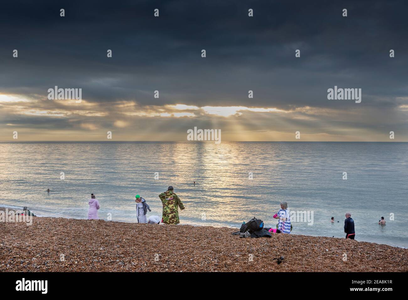 Dawn swimmers on Hythe beach, Kent Stock Photo Alamy