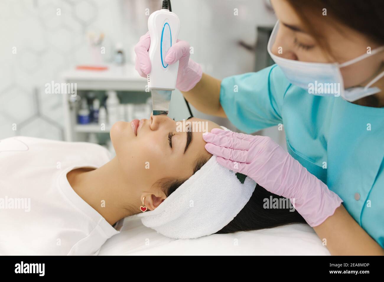 Young woman taking beauty procedure in spa salon Stock Photo - Alamy