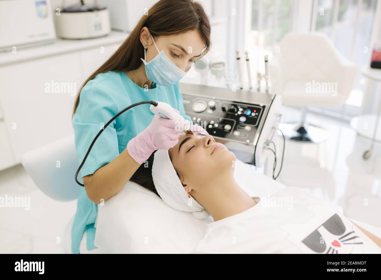 Young woman taking beauty procedure in spa salon Stock Photo - Alamy