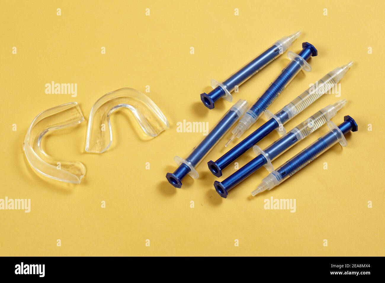 Home teeth whitening kit with peroxide gel syringes and rubber mouth