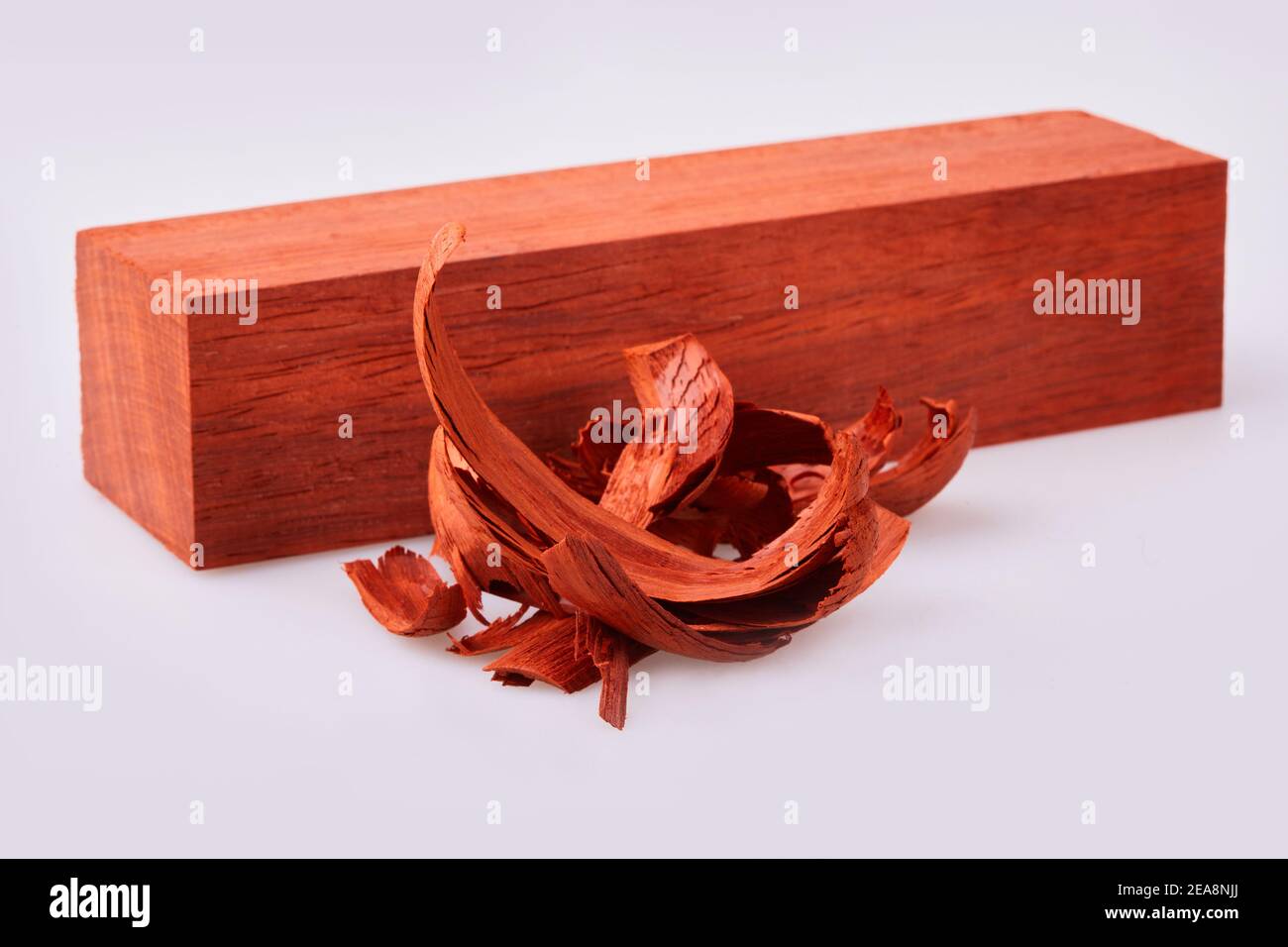 Colored wooden blocks with shavings isolated on white background. It is used for handmade wooden sculpturing Stock Photo