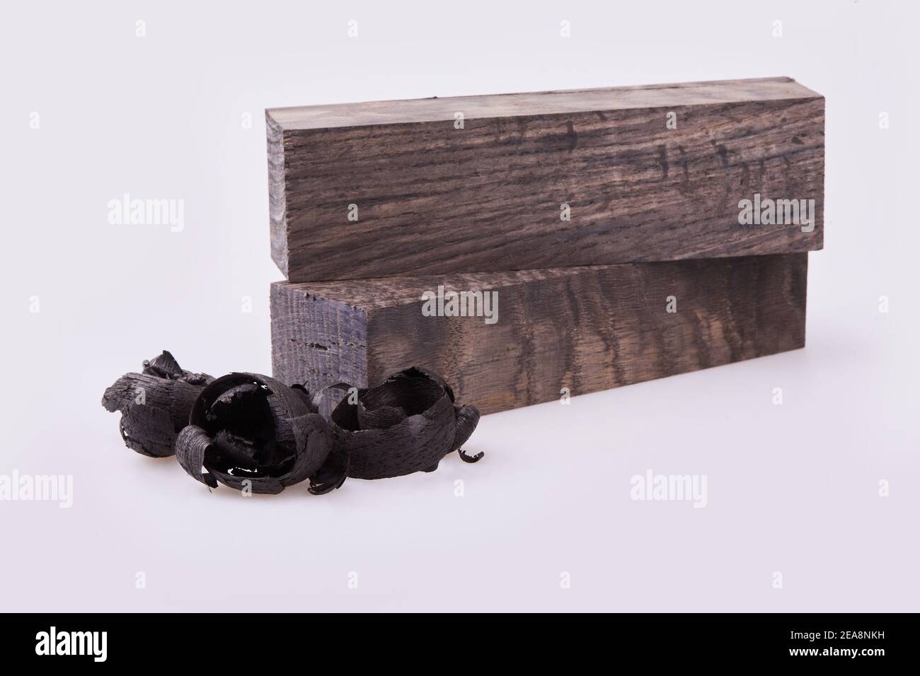 Colored wooden blocks with shavings isolated on white background. It is used for handmade wooden sculpturing Stock Photo