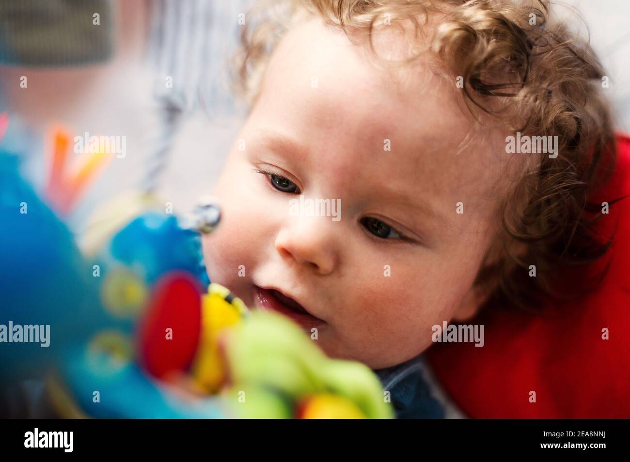 Baby boy exploring mobile toys Stock Photo
