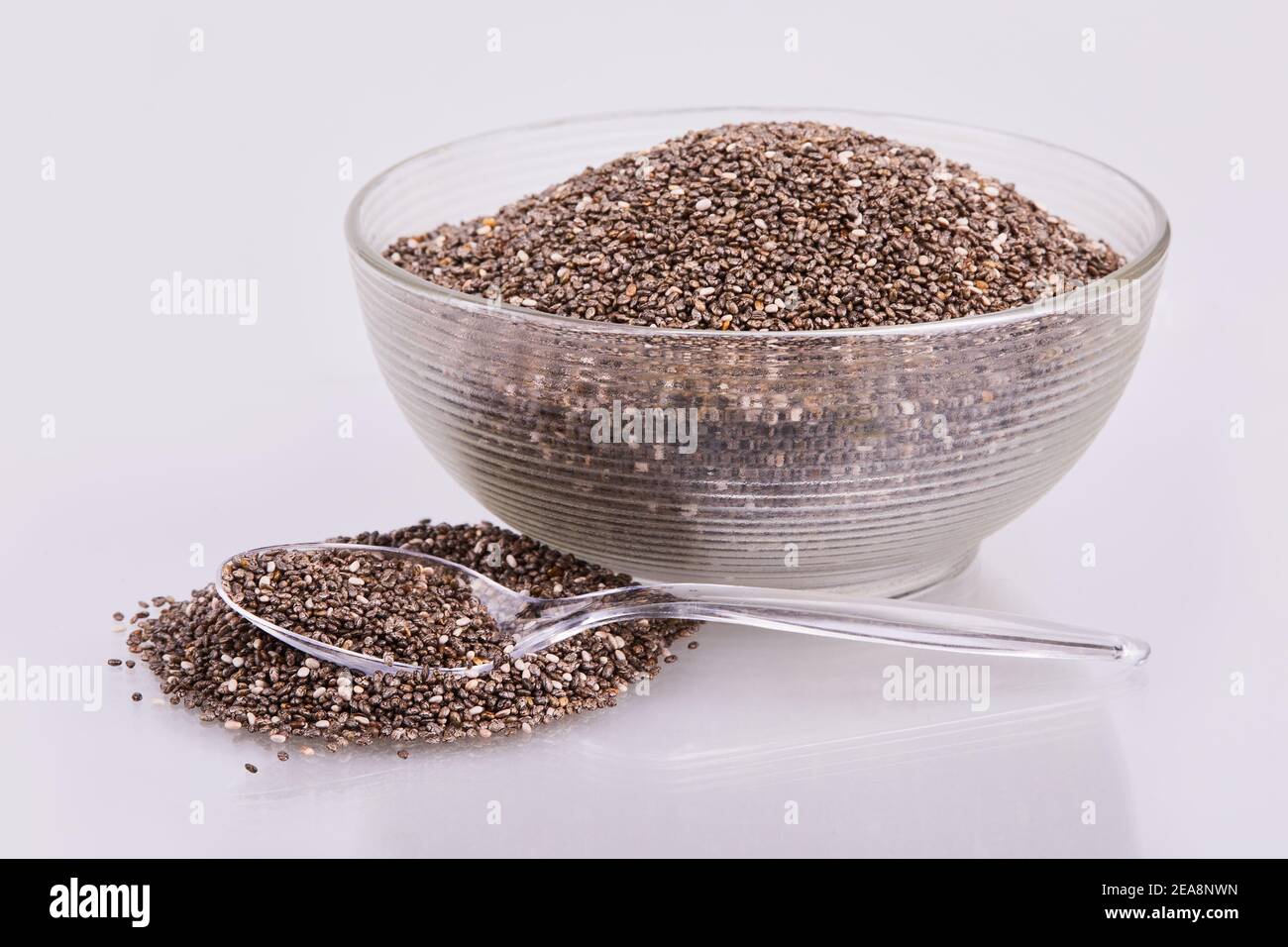 Healthy Chia seeds in transparent glass bowl isolated with white background Stock Photo