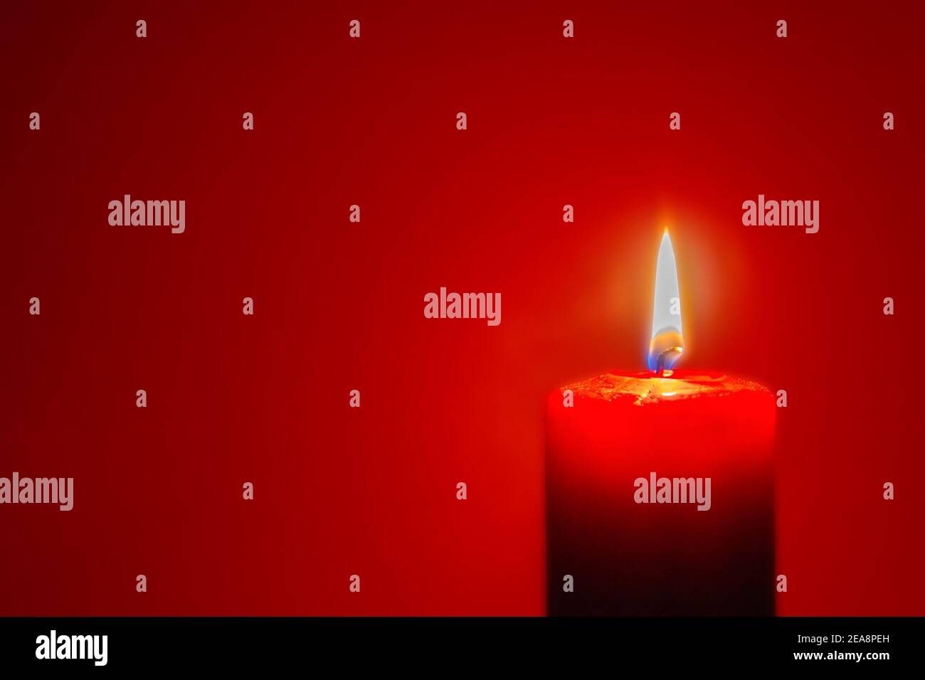Red candle burning on dark red background. Candlelight Stock Photo Alamy