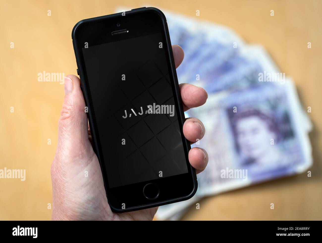 A woman using the Jaja banking app for a Jaja credit card Stock Photo