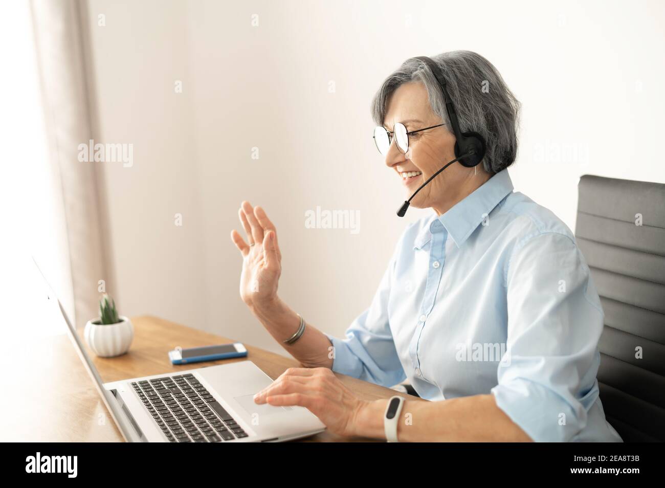 mature-woman-headset-laptop-webcam-hi-res-stock-photography-and-images