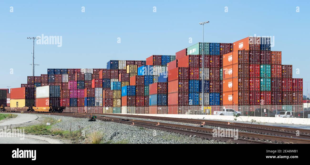 Sacked containers and train tracks shown in the Port of Los Angeles, California. Stock Photo