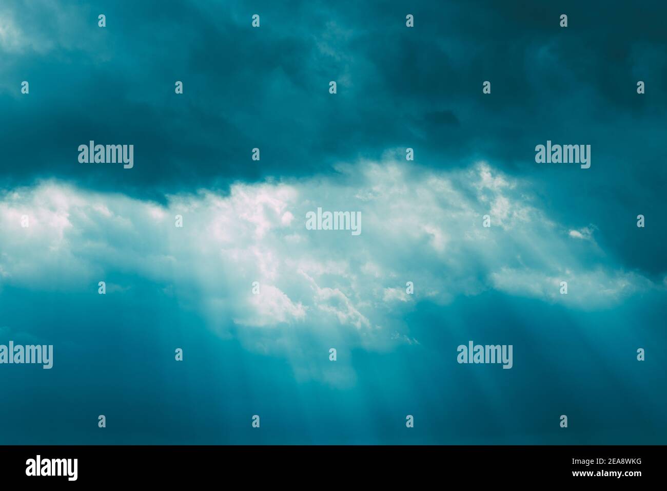 Sunrays Through Blue Rainy Dramatic Sky. Natural Abstract Background Stock Photo