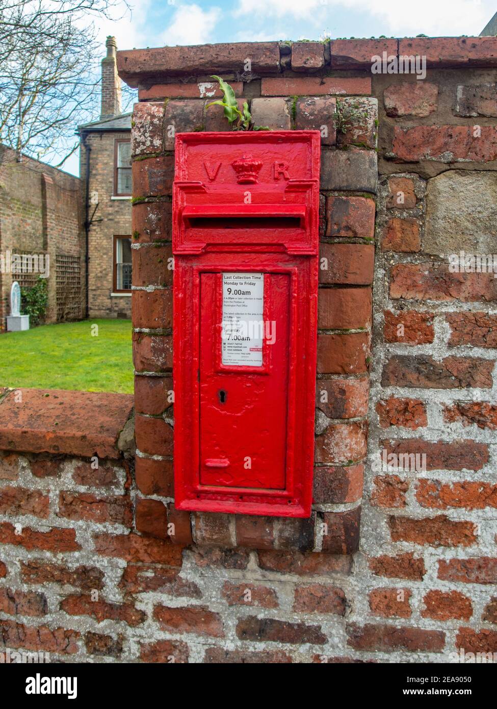 Pocklington, East Yorkshire, UK 12/01/2020 - Old victorian red post box built into a brick wall Stock Photo